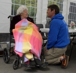 Team member with lady in wheelchair
